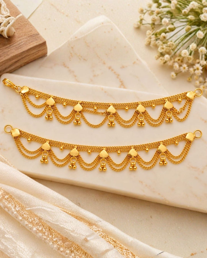 Gold plated traditional ear chains featuring multiple layered chain loops, decorative heart-shaped links, and tiny gold bead drops.