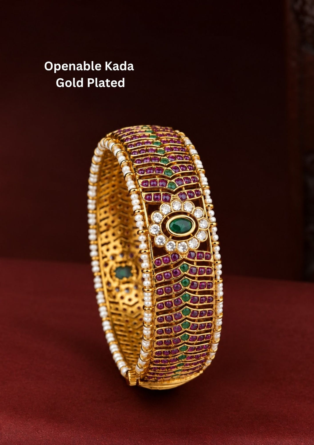 Premium Openable Gold Plated Kada showcasing an elegant oval green centerpiece, ruby stone work, crystal halo, pearl edges, and a hinged openable design.