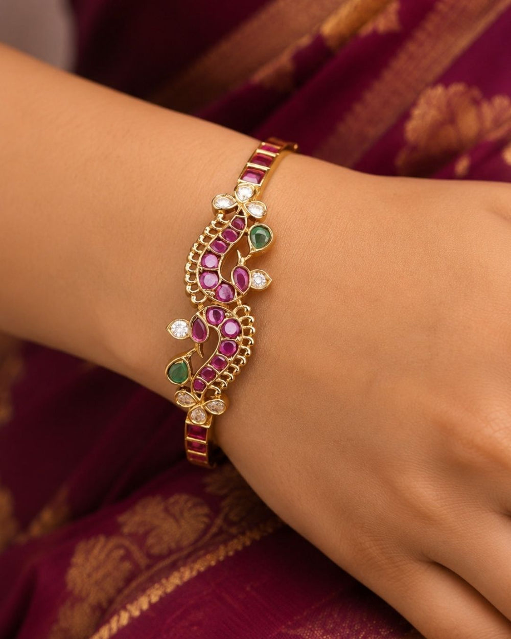 Beautiful gold plated openable bracelet featuring intricate floral detailing embellished with ruby and green stones and sparkling white stones, perfect for festive, traditional, and party wear.