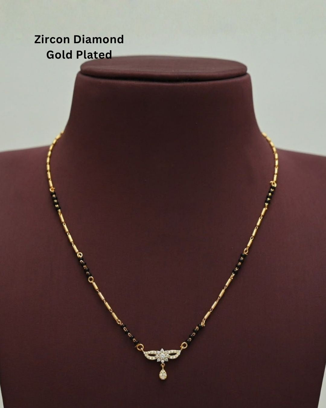 Stylish gold plated mangalsutra featuring black beads, delicate gold detailing, a sparkling CZ pendant, and a teardrop embellishment, perfect for everyday and traditional wear.