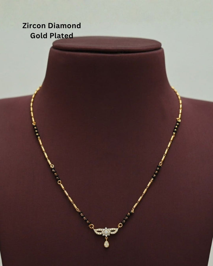 Stylish gold plated mangalsutra featuring black beads, delicate gold detailing, a sparkling CZ pendant, and a teardrop embellishment, perfect for everyday and traditional wear.