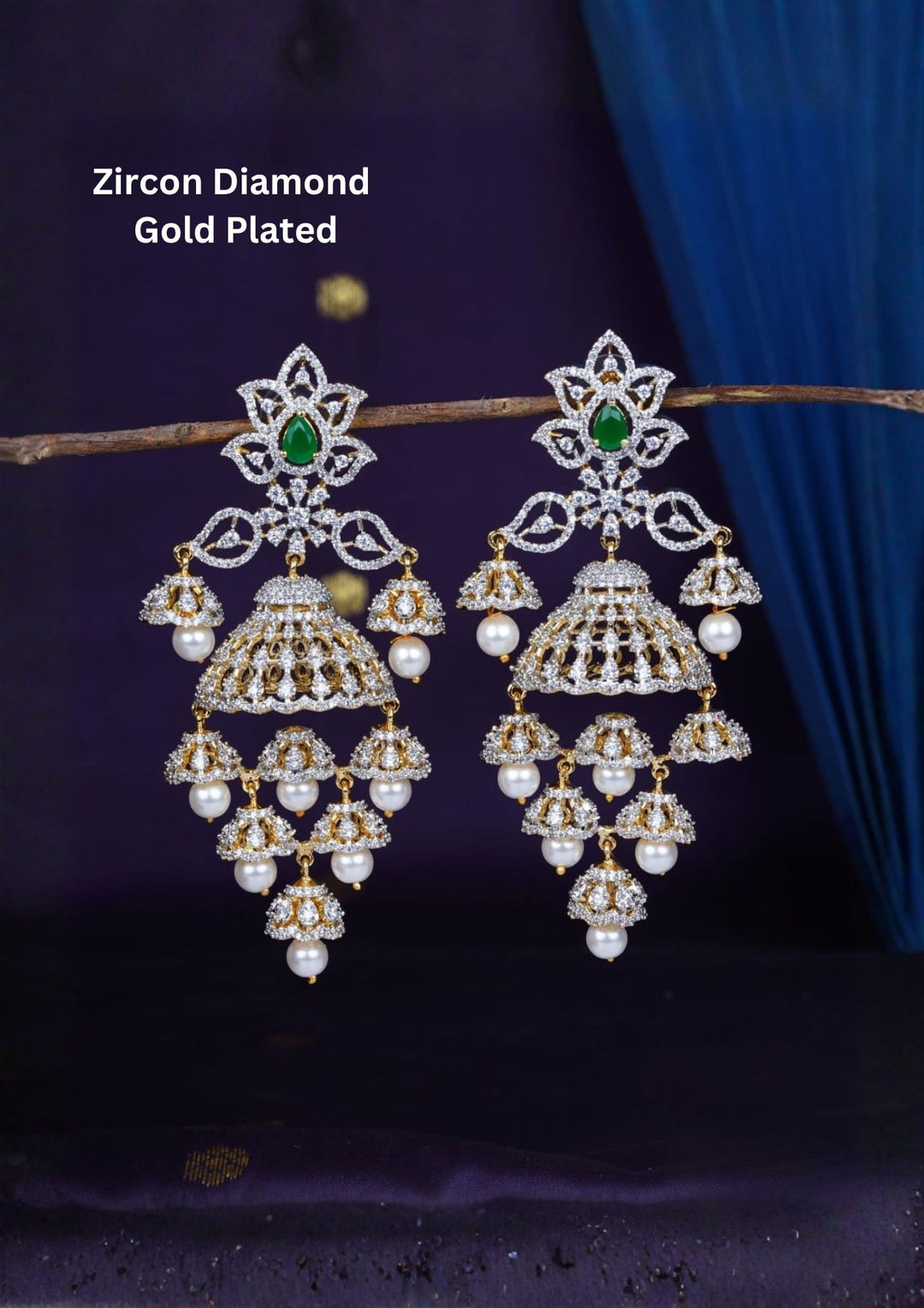 Gold-plated zircon diamond finish multi-tier jhumka earrings designed with dazzling CZ crystals, with a green tear-drop accent stone, and delicate hanging white pearls that give a graceful traditional and modern look for receptions, sangeet, luxury weddings, and party wear styling with lightweight comfortable use and COD available now.
