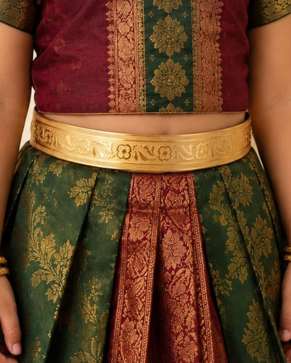 Beautiful gold plated kids’ hip belt featuring a wide engraved band with intricate floral and peacock-inspired detailing. Perfect for babies and kids, traditional wear, weddings, festive occasions, cultural events, and gifting.