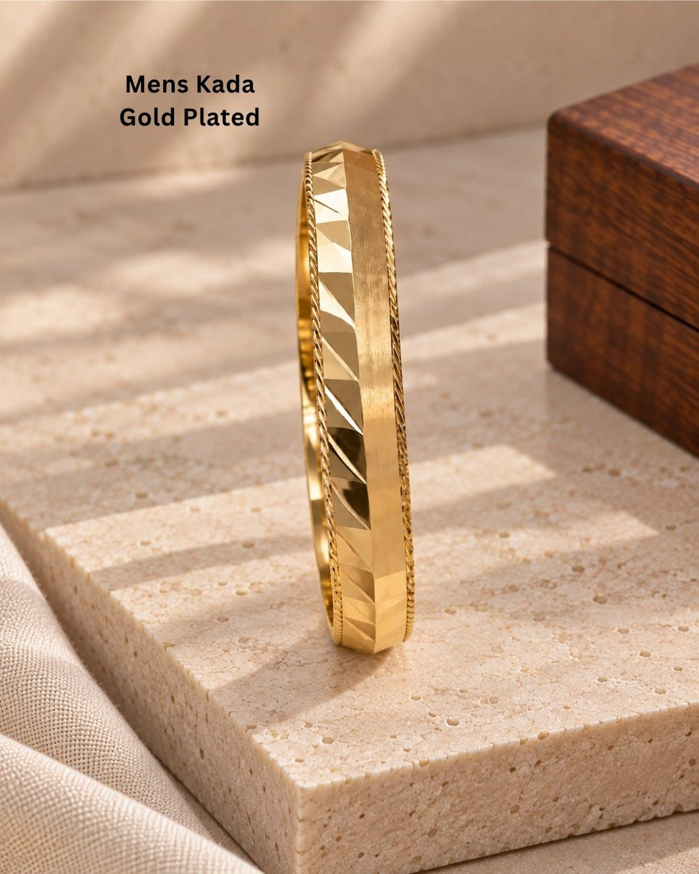 Elegant gold plated men’s kada featuring a broad geometric patterned band with polished finish and twisted border detailing, perfect for traditional and modern wear.
