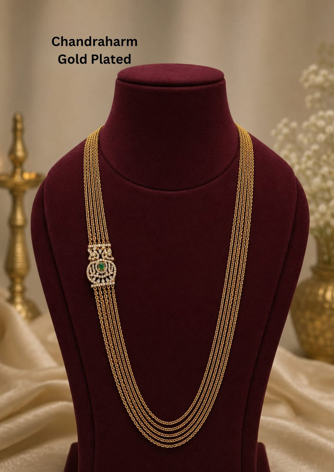 Elegant multi layer Chandraharam gold plated haram featuring fine layered chains with a beautifully crafted zircon centerpiece accented by a green stone. Perfect for weddings and festive occasions.