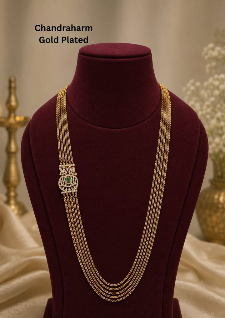 Elegant multi layer Chandraharam gold plated haram featuring fine layered chains with a beautifully crafted zircon centerpiece accented by a green stone. Perfect for weddings and festive occasions.