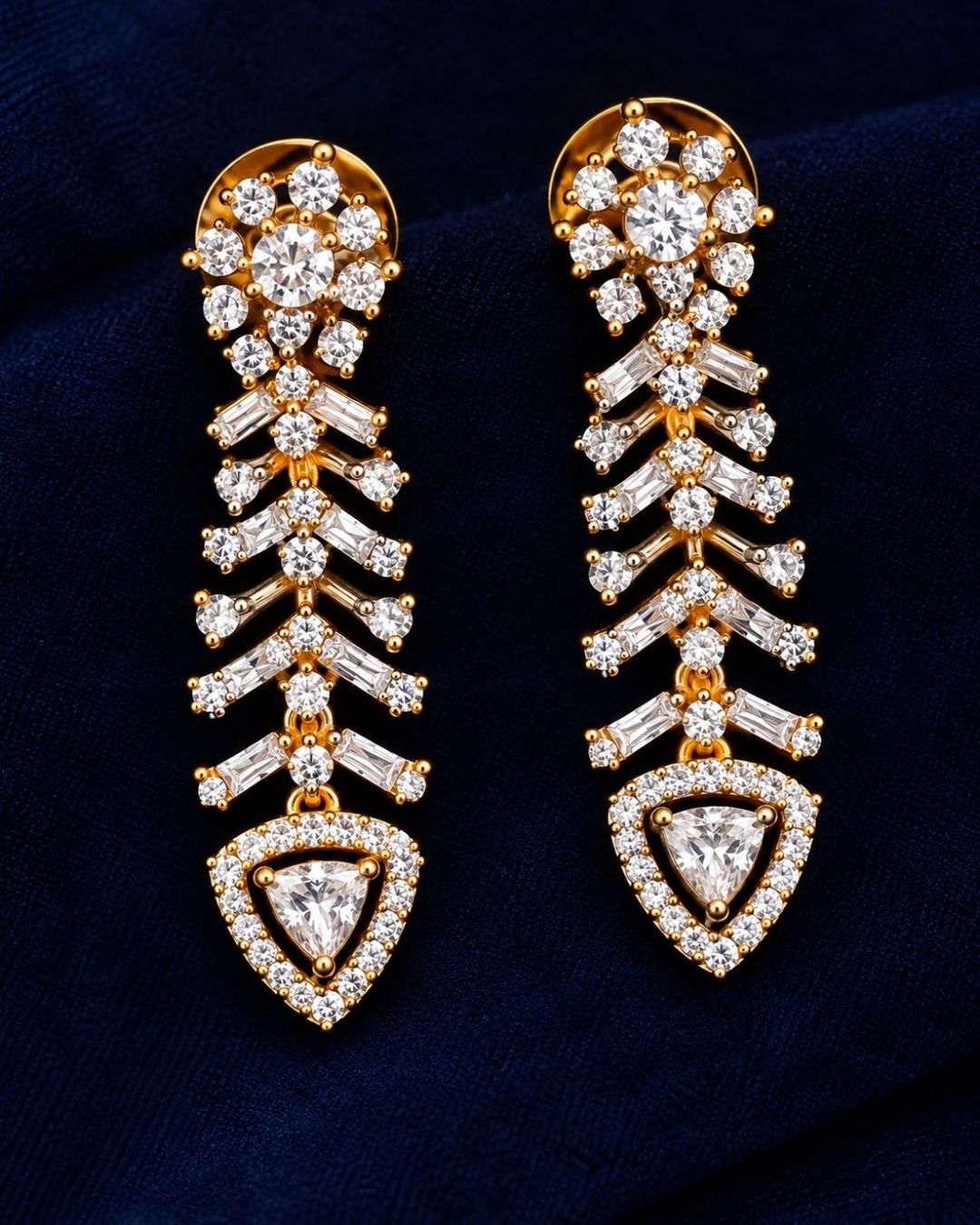 gold plated V-shaped collar necklace with a modern Art Deco aesthetic. The structured necklace features alternating diagonal bars encrusted with micro pure Zirconian diamonds, creating a shimmering chevron fringe that culminates in a central teardrop crystal pendant, complete with matching drop earrings.