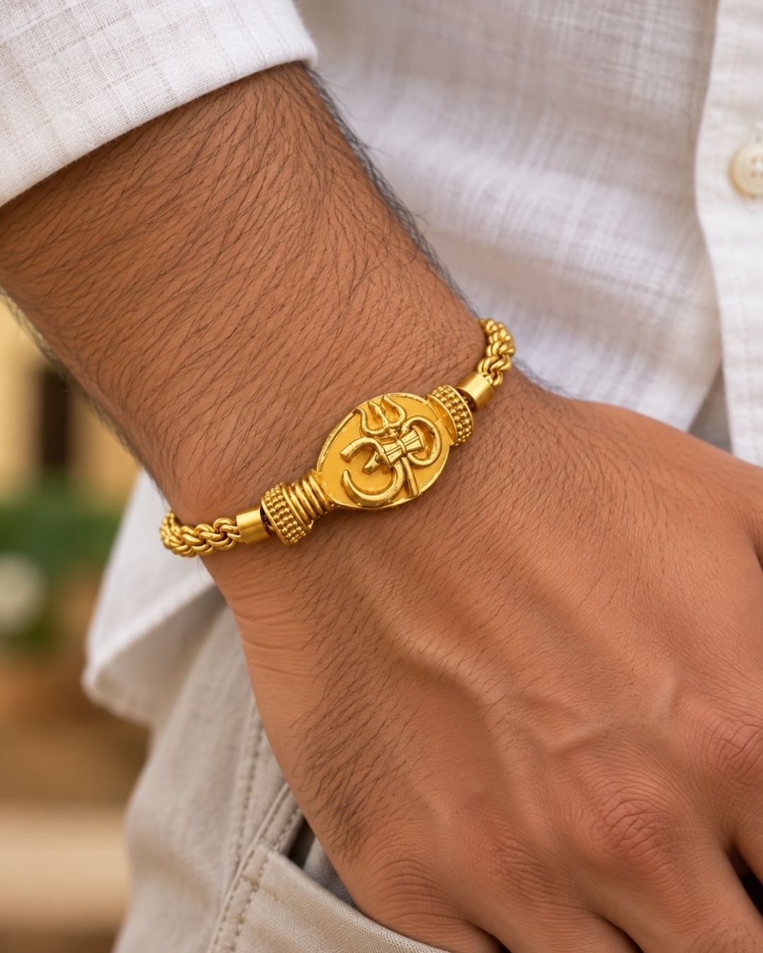 Elegant gold plated men’s bracelet featuring a beautifully detailed Om pendant, braided chain pattern, and polished gold finish, perfect for daily wear, festive occasions, and traditional styling.