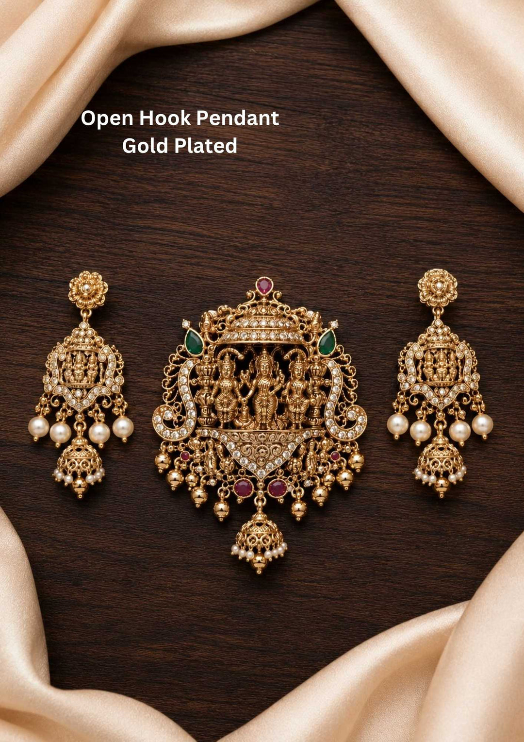 Antique gold plated open hook temple pendant depicting the divine Rama Darbar with Lord Ram, Sita, Laxman, and Hanuman, accented with rubies, emeralds, and hanging pearls. Pairs with matching chandelier jhumka earrings.