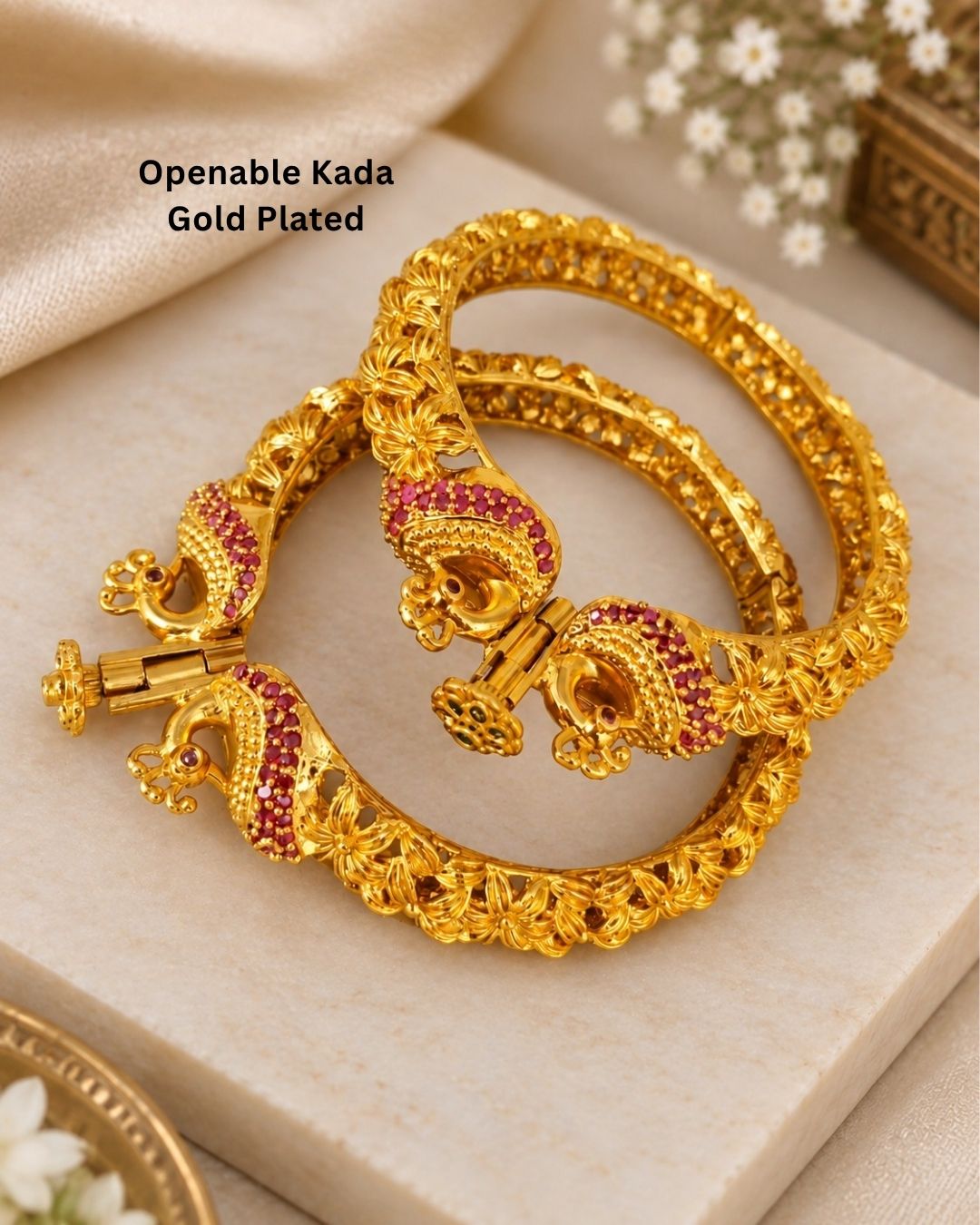 Designer Openable Peacock Gold Plated Kankanalu with floral engraved detailing, ruby-inspired embellishments, intricate craftsmanship, and an elegant hinged design.