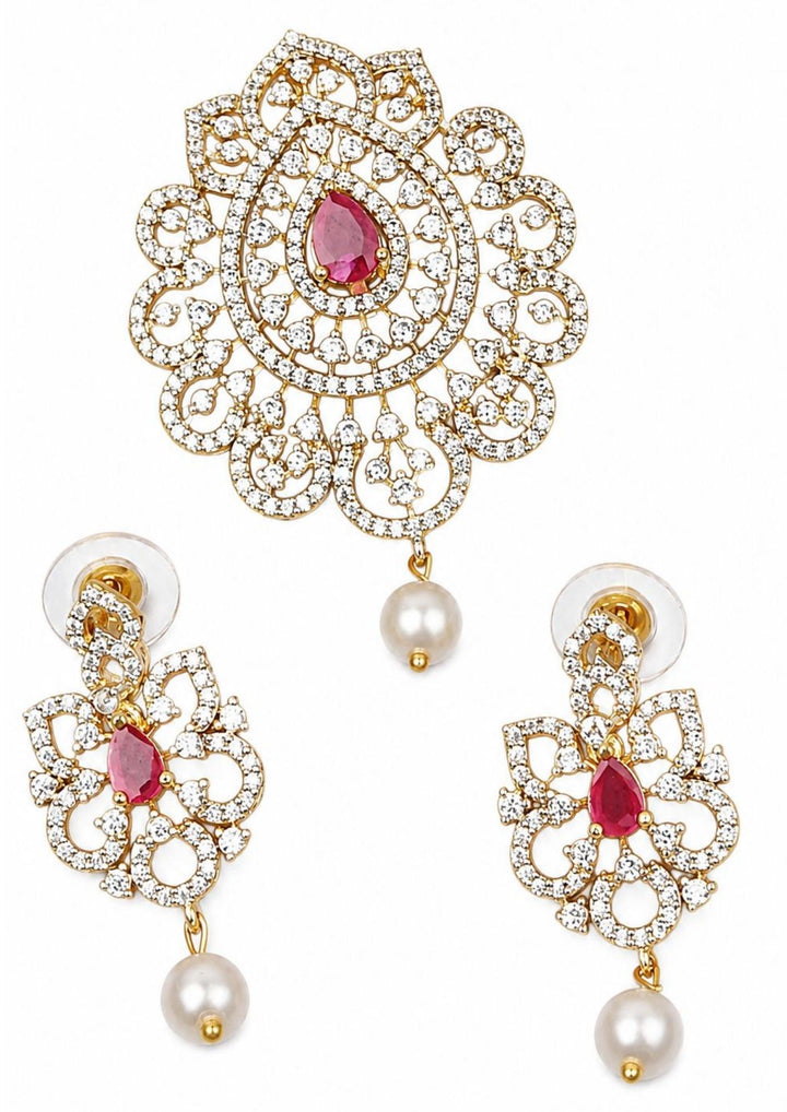 Elegant zircon diamond gold plated pendant set featuring a floral-inspired pendant designed with sparkling white zircon stones arranged in circular patterns. The centerpiece showcases a pear-shaped emerald red stone surrounded by dazzling zircon stones, finished with a delicate pearl drop. The matching earrings mirror the same floral design with green stone and pearl danglers, Perfect for weddings, festivals, office wear, functions and its anti fade color