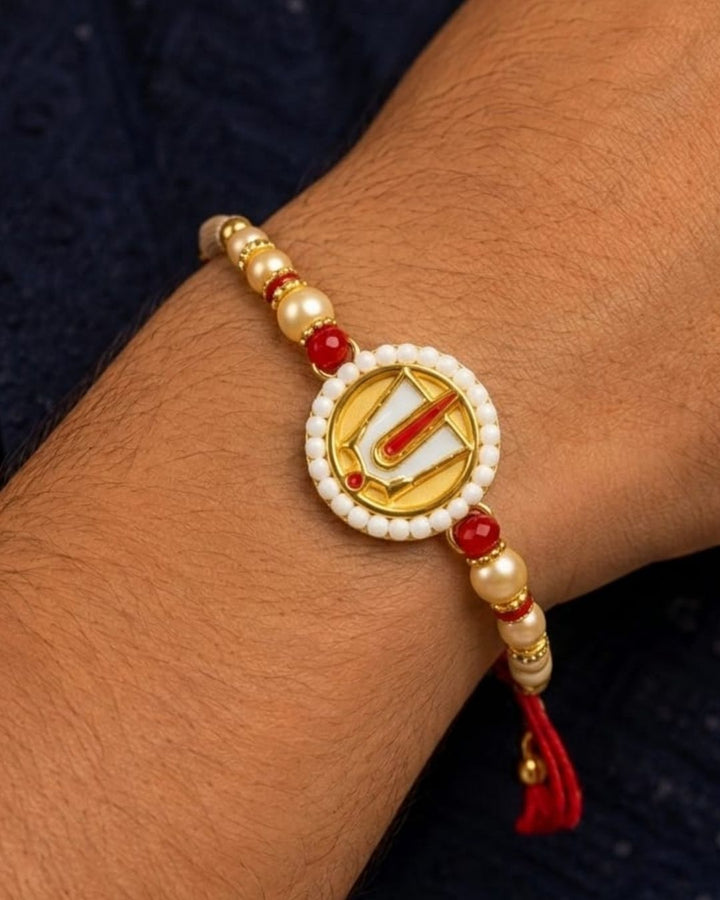 A beaded wrist chain or rakhi-style bracelet worn on a person&