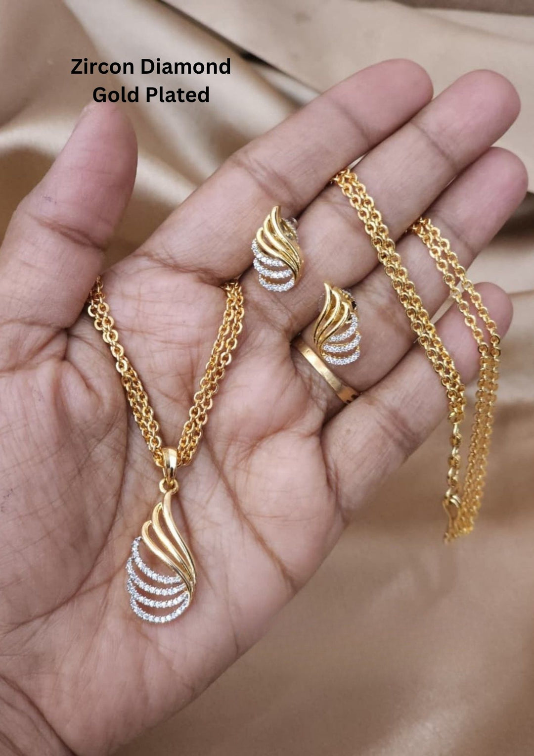 Gold plated zirconian diamond pendant necklace with matching earrings featuring an elegant leaf-inspired design with matching earrings crafted in a stylish gold plated finish. Ideal for gifting and everyday elegance.