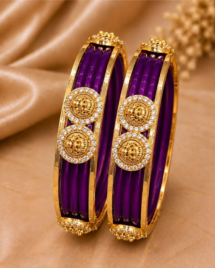 Traditional gold plated interchangeable bangles featuring rich red detailing, polished gold borders, circular motifs embellished with sparkling white stones, and decorative bead accents, perfect for festive, wedding, and traditional occasions.