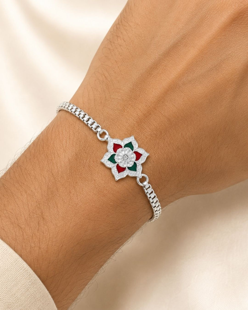 Traditional Silver Plated Floral Rakhi Bracelet with a finely crafted flower design, colorful enamel accents, intricate craftsmanship, and a durable silver-tone chain.
