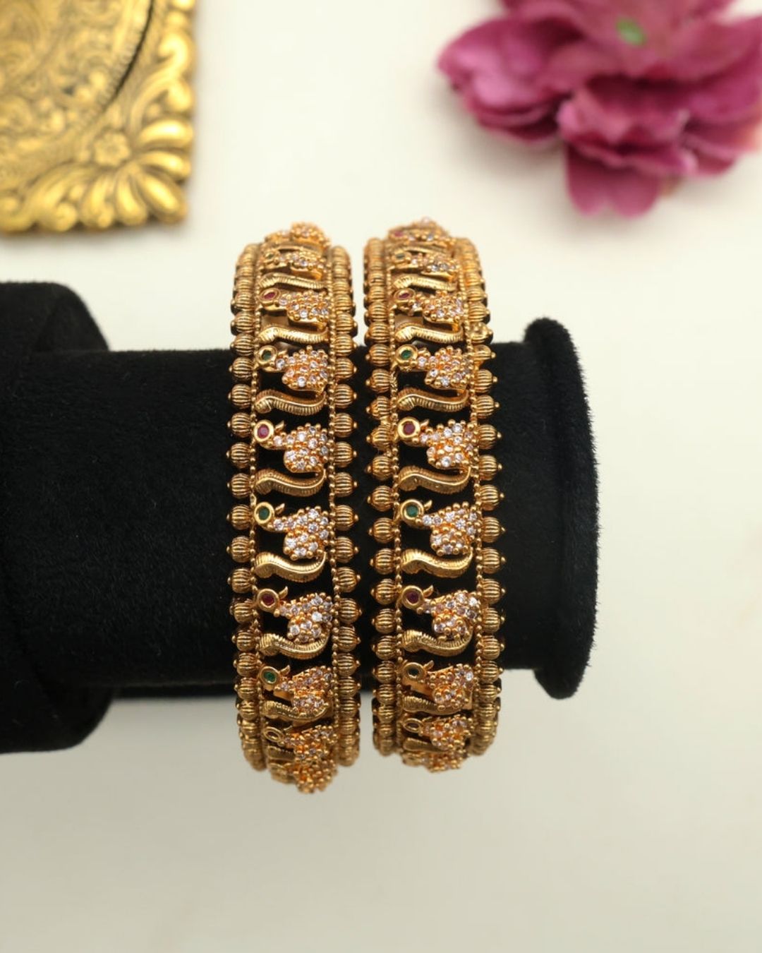 Premium gold plated designer bangles featuring repeating floral zircon motifs with textured gold bead detailing. Perfect for traditional wear, festive occasions, weddings, and gifting.
