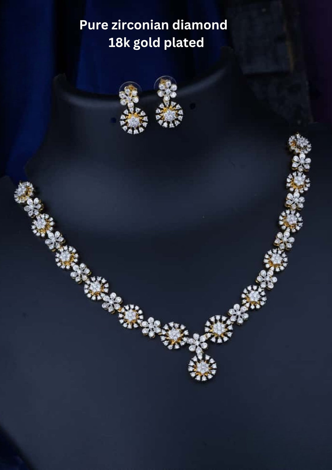 Necklace and earrings set with zirconian diamonds and 18k gold plating on a dark background