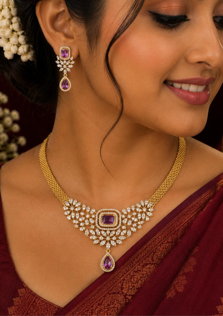 South Indian Women wearing a Designer purple zircon diamond necklace set with matching drop earrings, crafted with brilliant diamond-look stones and vibrant purple gemstones. Perfect for sarees, gowns, lehengas and festive celebrations.