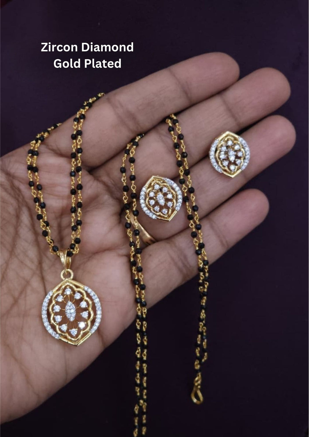 Elegant gold plated mangalsutra set with zircon diamond pendant, matching earrings and premium black bead chain.erfect for everyday elegance.