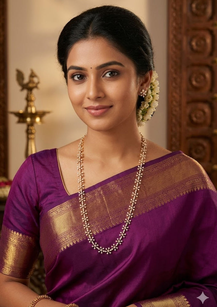South Indian women wearing  Pure Zirconian Diamond Gold Plated long chain necklace and matching stud earrings set. The jewelry designed with floral pattern made of sparkling cube zirconia stones on a gold-plated base for festivals, temple visits, weddings, functions and dailywear