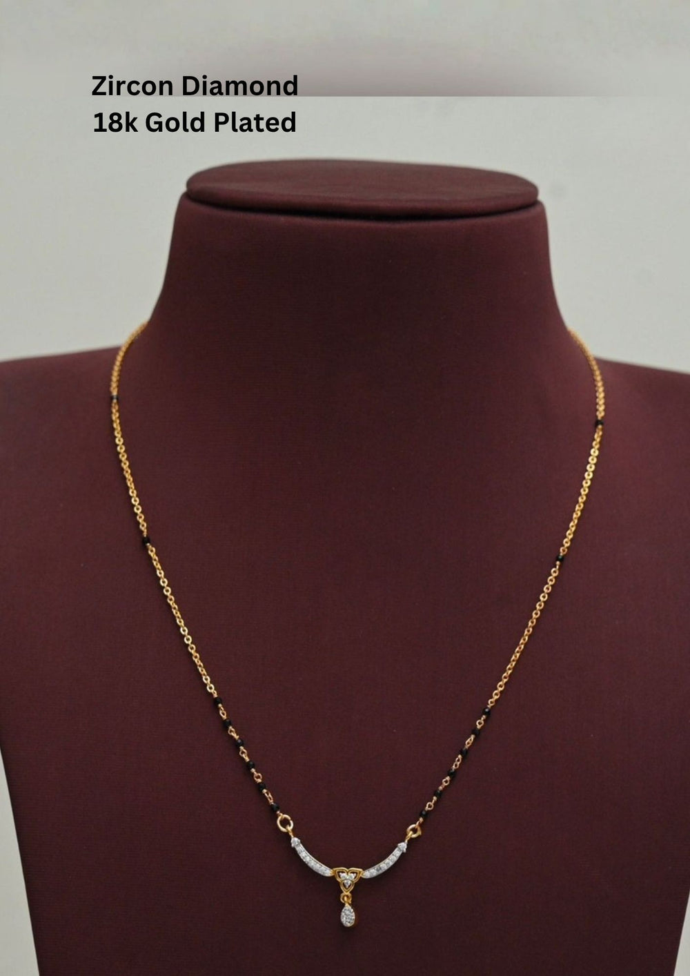 Gold plated black beads mangalsutra featuring an elegant heart-shaped zircon centerpiece with a delicate drop pendant. Designed with a graceful 18–20 inch chain, making it perfect for daily wear, festive occasions, and gifting.