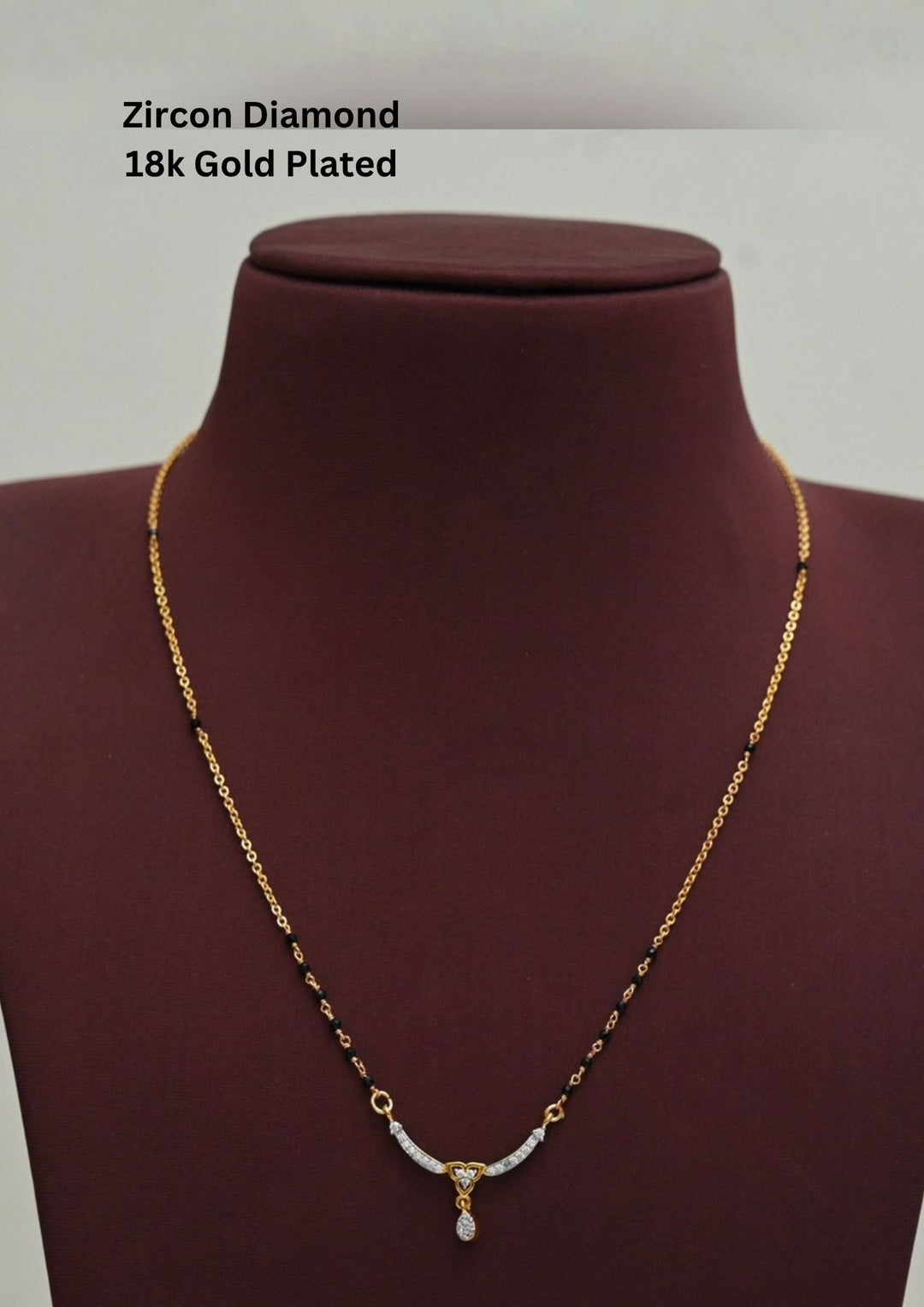 Gold plated black beads mangalsutra featuring an elegant heart-shaped zircon centerpiece with a delicate drop pendant. Designed with a graceful 18–20 inch chain, making it perfect for daily wear, festive occasions, and gifting.