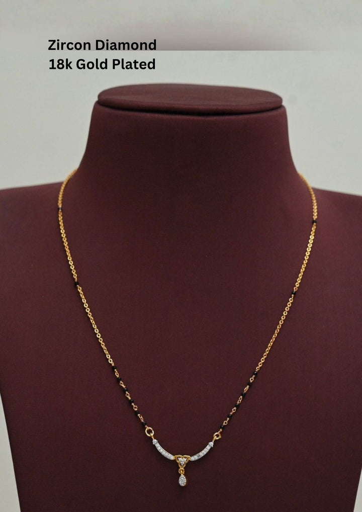 Gold plated black beads mangalsutra featuring an elegant heart-shaped zircon centerpiece with a delicate drop pendant. Designed with a graceful 18–20 inch chain, making it perfect for daily wear, festive occasions, and gifting.