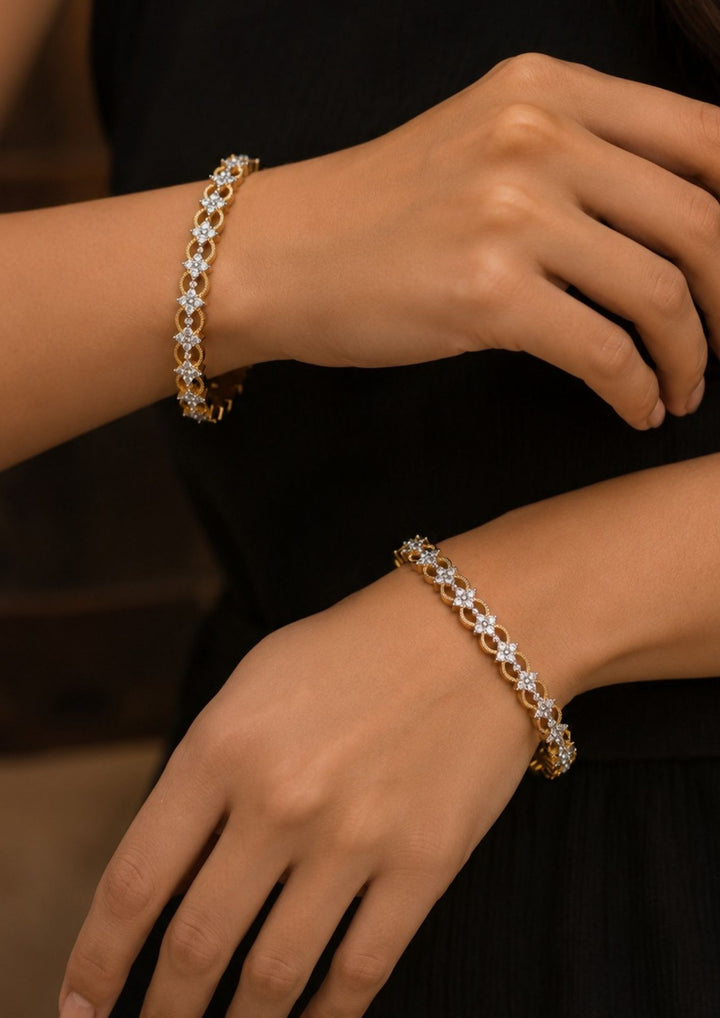 Close-up of hands wearing Gold-plated zircon diamond bangles comes with set of 2 and looks vert clear in picture how it looks and also in ide the bangle also in detailed and can be used for office ware , festivals and functions 