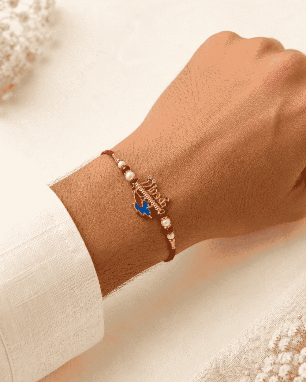 Premium Krishna Flute Rakhi with gold plated finish, peacock feather enamel charm, pearl accents, and red thread, perfect for Raksha Bandhan celebrations.