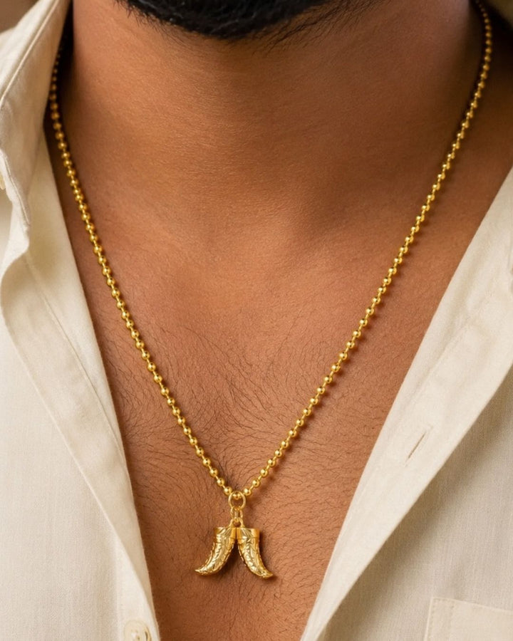 Beautiful gold plated necklace featuring a repeating beaded chain and a distinctive pair of curved horn-shaped pendants at the center. Perfect for traditional wear, festive occasions, weddings, parties, daily wear, and gifting.