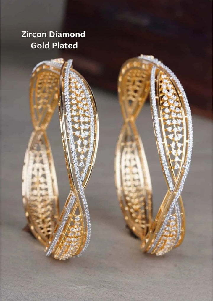 gold plated openwork kada bangles engineered with a fluid, twisted wave ribbon silhouette. The structural design features an intricate inner golden lattice grid flanked by a continuous outer track of closely set, micro-pave white pure Zirconian diamond crystals.