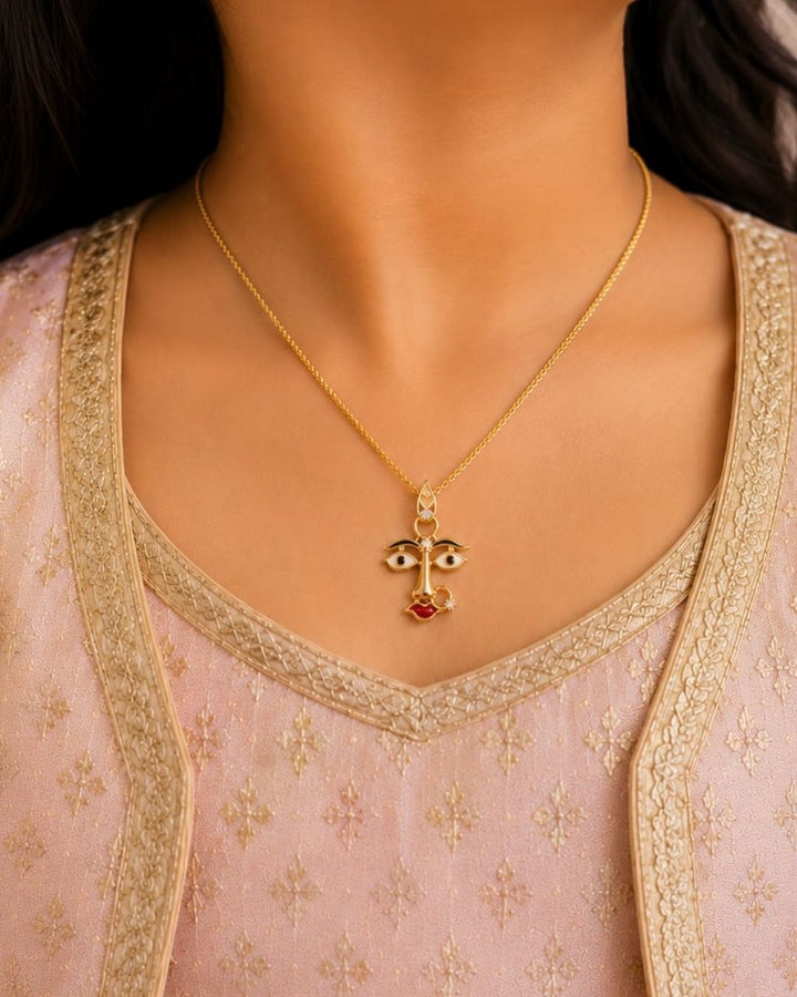 Beautiful divine face gold plated pendant chain featuring artistic enamel detailing and a sleek gold finish. Perfect for daily wear, festive occasions, temple visits, traditional outfits, and premium gifting.