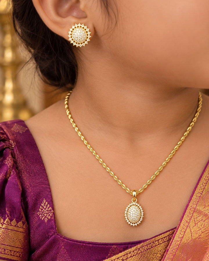 18k gold plated jewelry set featuring a twisted rope chain with an oval pendant densely studded with pure zirconian diamonds, paired with matching round floral-edged diamond stud earrings. This lightweight jewelry set is crafted with a premium gold finish that provides a rich, sparkling appearance suitable for weddings, parties, festivals, family functions, office wear, kurtis, and modern or traditional outfits with skin-friendly quality, anti-fade polish, comfortable fitting, and Cash on Delivery available