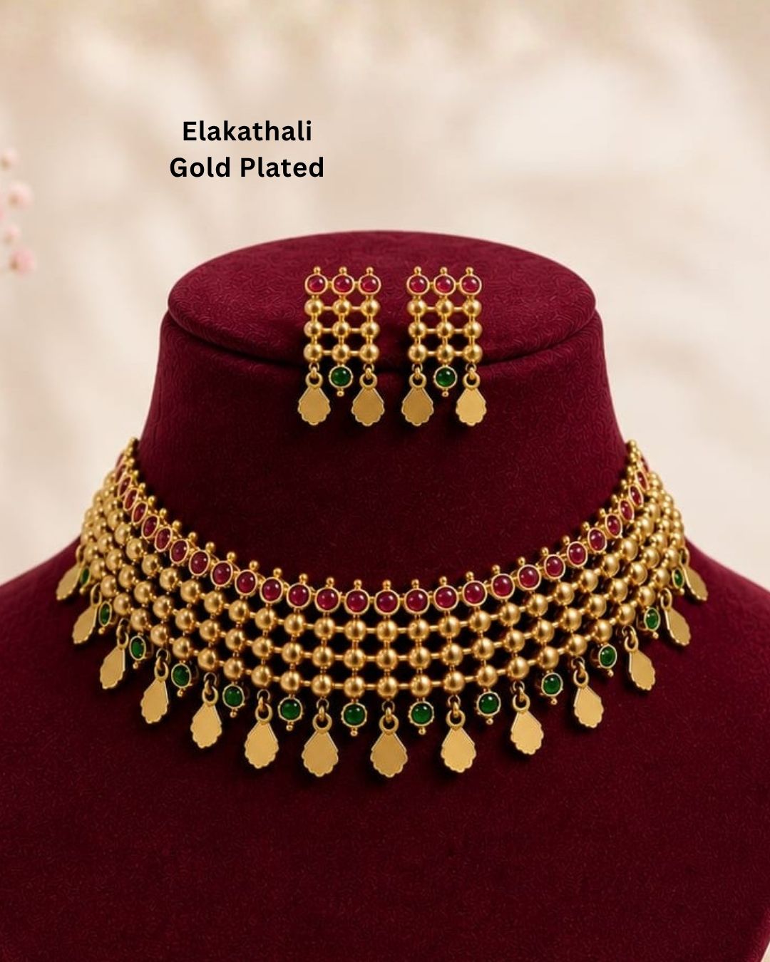 South Indaian women Beautiful Jadau Kundan gold plated necklace set featuring an intricate multi-layered choker design with ruby and green stones, detailed gold beadwork, dangling motifs, and matching earrings. Perfect for festive occasions, traditional wear, weddings, and gifting.