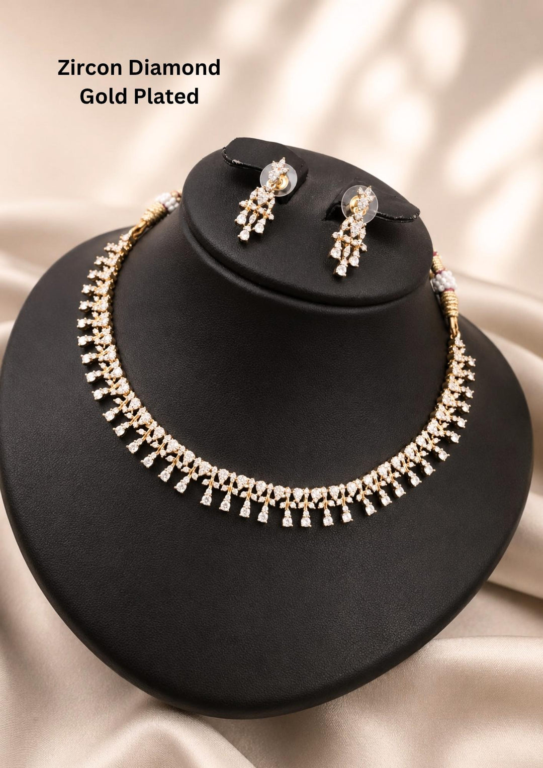 gold plated jewelry set featuring a sleek choker band adorned with a continuous row of delicate, dangling vertical fringe drops studded entirely with sparkling white pure zirconian diamonds. The matching hanging earrings feature a coordinating tiered diamond drop design. Perfect for weddings, parties, receptions, and festive celebrations with skin-friendly quality, comfortable fitting.
