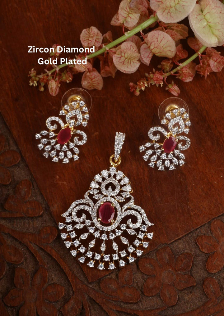 Zircon diamond gold plated pendant and earring set featuring a large open teardrop style chandelier pendant filled with tiers of shimmering white zircons and an oval-cut central ruby red gemstone. This lightweight matching set comes with smaller identical teardrop ruby earrings, providing an exceptionally brilliant diamond-look appearance suitable for weddings, receptions, festivals, cocktail parties, sarees, gowns, and ethnic fusion wear with skin-friendly quality, anti-fade premium polish, comfortable 