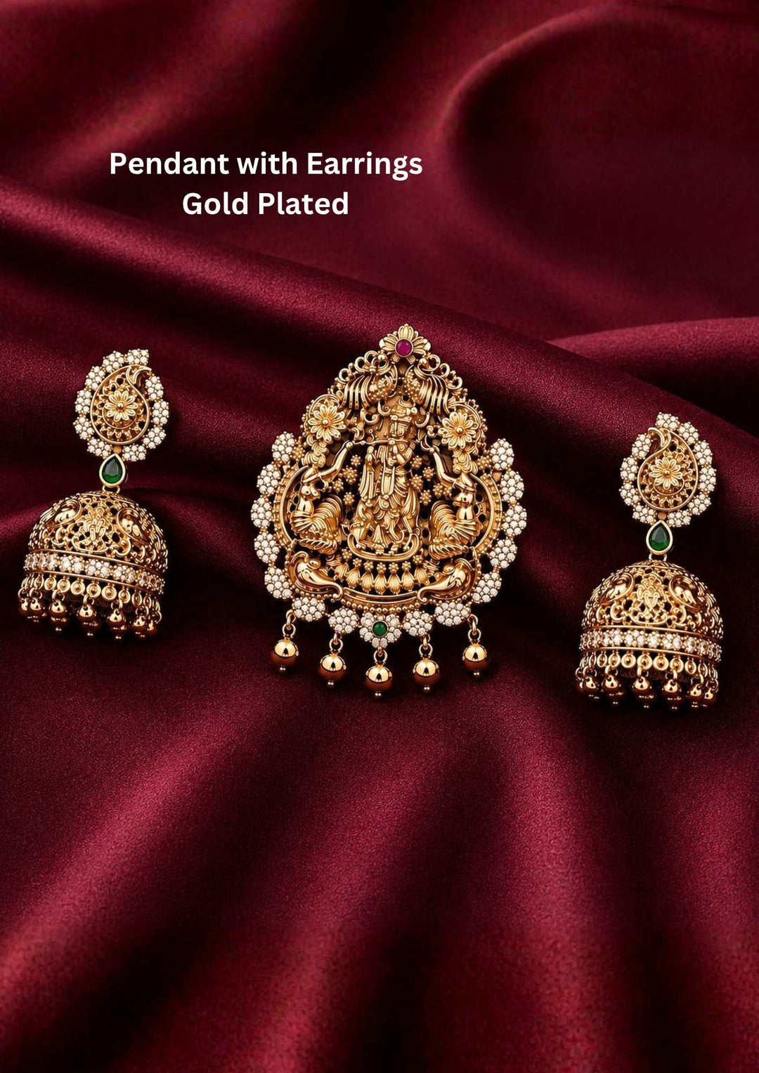 An antique gold plated temple jewelry set featuring a large teardrop-shaped pendant intricately carved with Lord Krishna playing the flute, flanked by two detailed peacocks. The pendant is beautifully framed by rows of tiny white rice pearls and small hanging gold balls. The set comes complete with matching dome-shaped jhumka earrings featuring emerald green stone connectors.