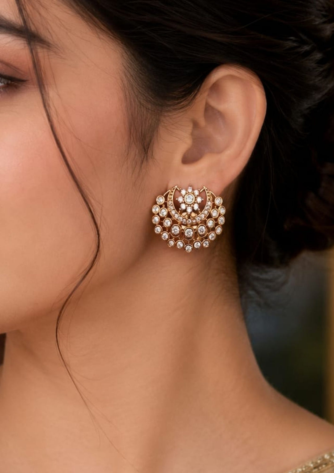 close-up view of a south Indian women wearing a polki studs in the shape of half moon with white zircon diamonds.and can use for traditional , office ware , daily ware and for gifting 