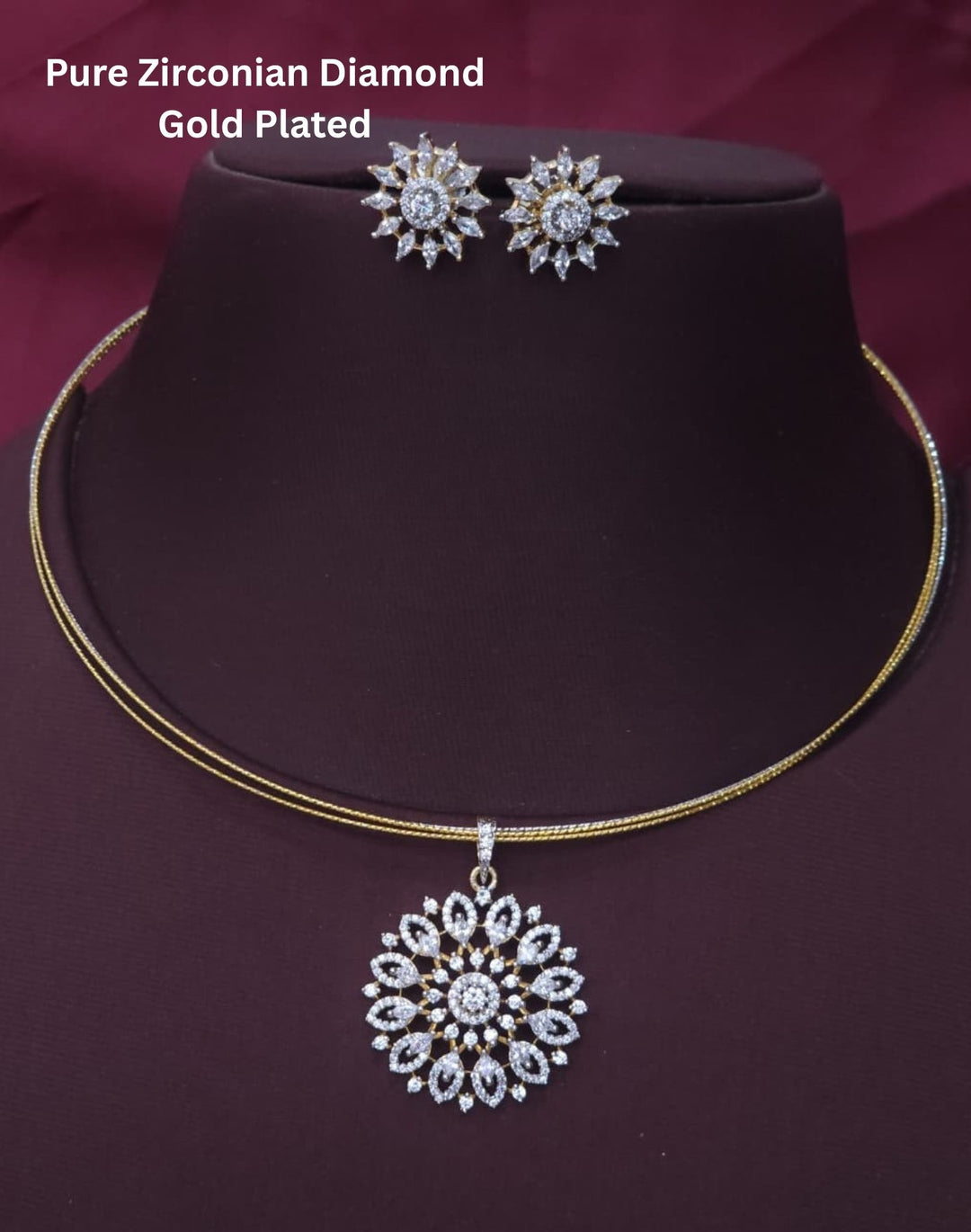 Premium gold plated necklace set featuring a large floral-inspired zircon pendant surrounded by sparkling stones, paired with matching floral stud earrings. Perfect for weddings, festive occasions, parties, traditional wear, and gifting.