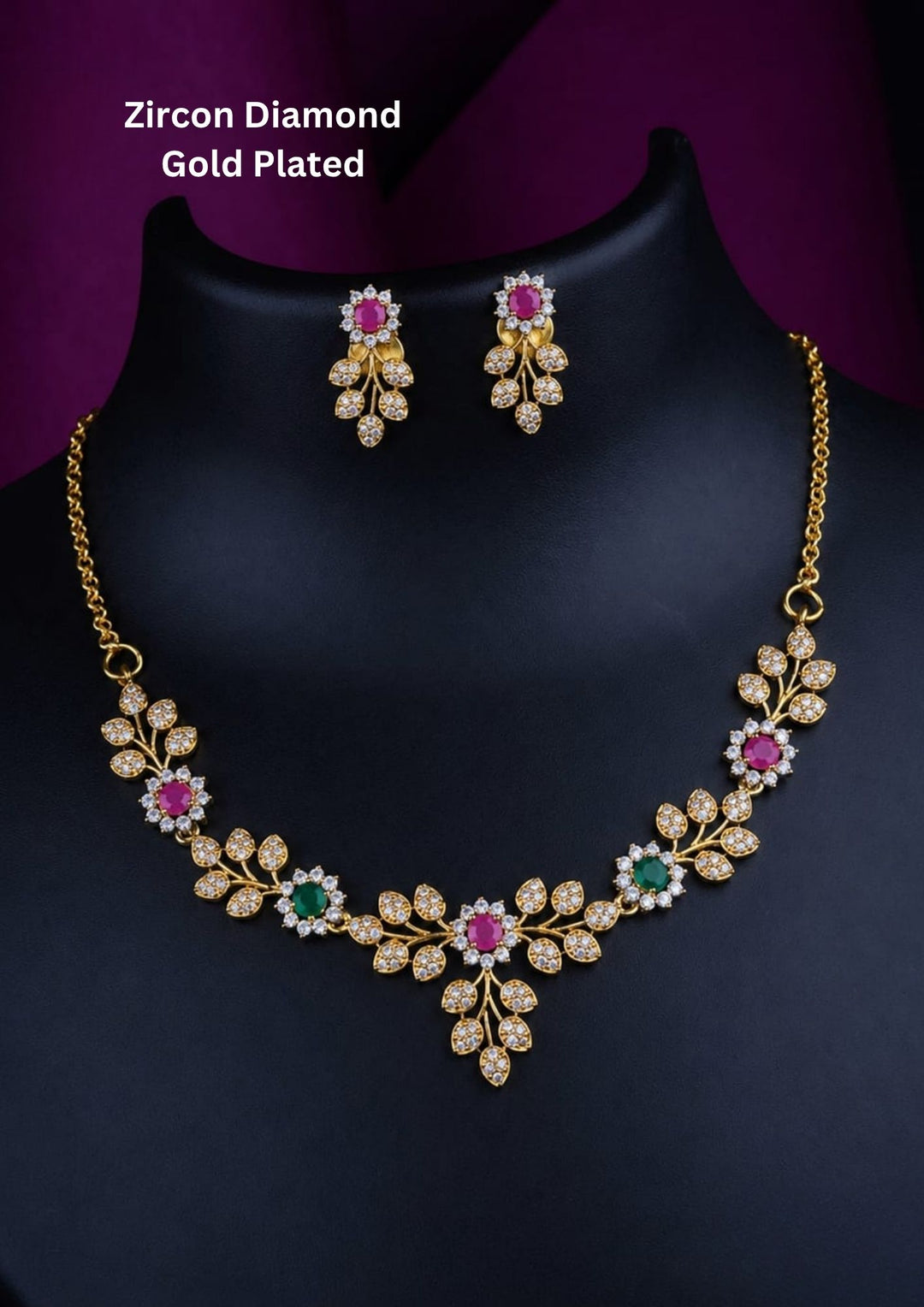 Elegant zircon diamond gold plated necklace set featuring sparkling leaf-shaped zircon motifs arranged in a graceful floral vine pattern. The necklace is highlighted with vibrant pink and green center stones surrounded by shimmering white zircon accents, creating a sophisticated and feminine look. The matching floral drop earrings complement the necklace beautifully, making it ideal for weddings, receptions, parties and festive occasions.