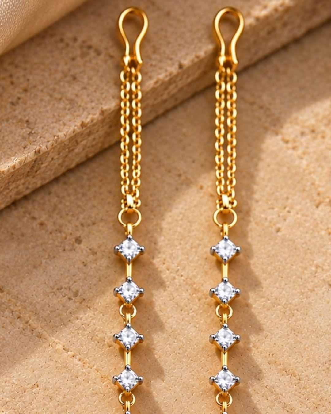 Gold plated designer ear chains featuring sparkling white square zircon stones arranged in a vertical pattern with delicate gold links.