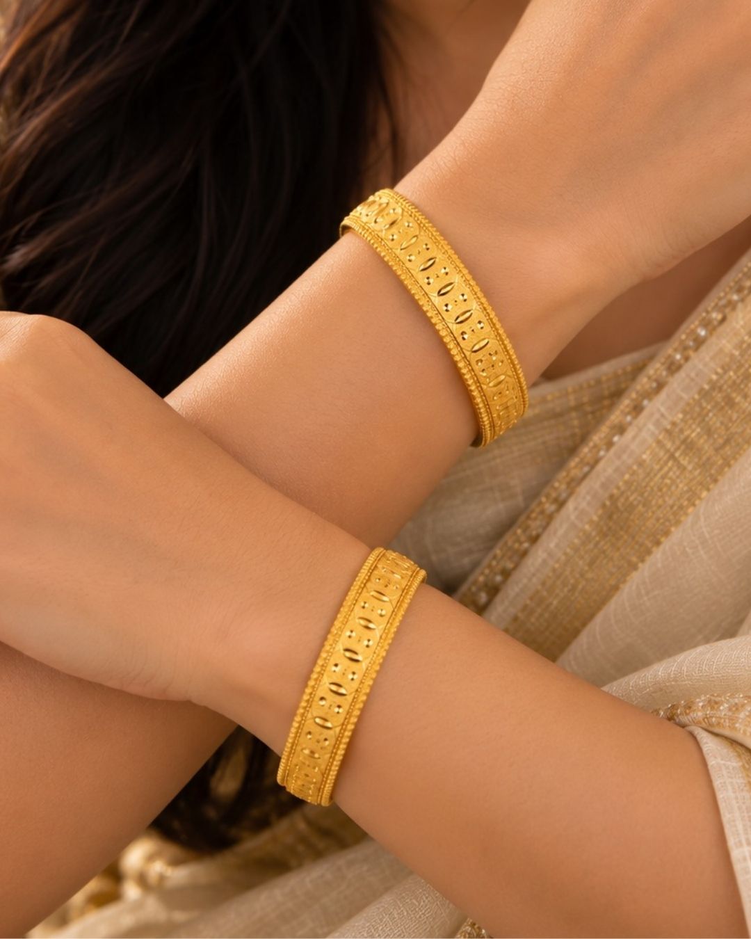 Traditional gold plated designer bangles featuring detailed repeating embossed motifs, textured borders, and a polished gold finish, perfect for festive, wedding, and traditional occasions.