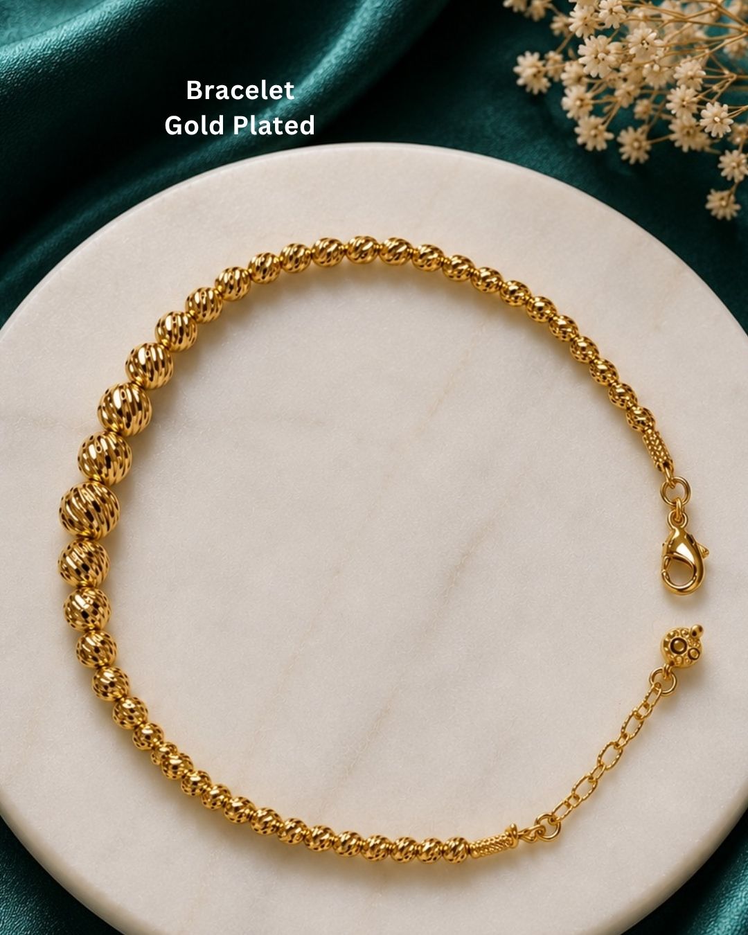 Beautiful gold plated beaded bracelet featuring a sequence of intricately textured round beads, delicate chain detailing, and a polished finish. Perfect for everyday wear, festive occasions, traditional outfits, parties, and gifting.