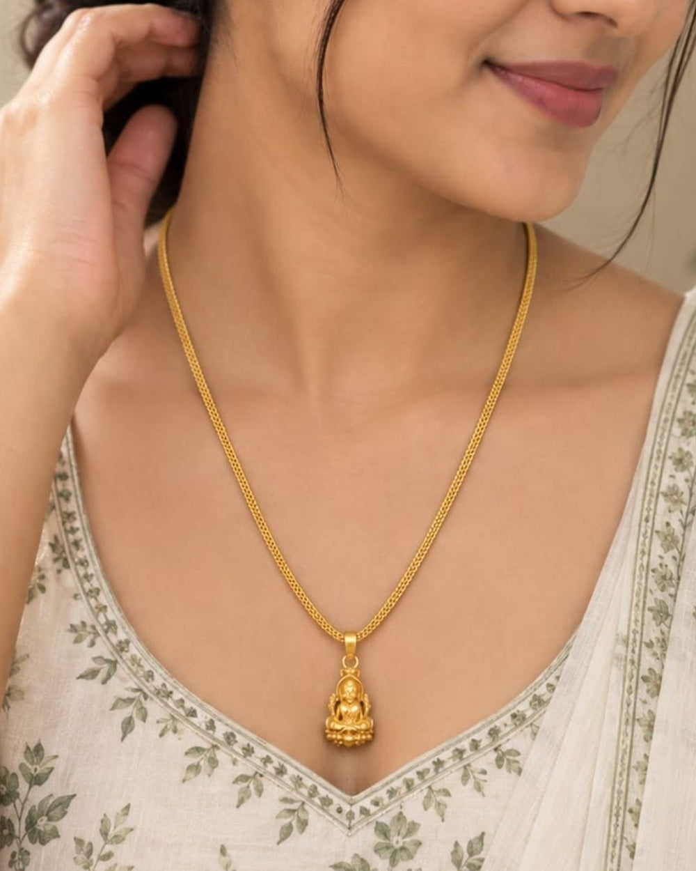 Beautiful gold plated necklace featuring a delicate textured chain and a traditional Lakshmi goddess pendant with intricate detailing. Perfect for traditional wear, festive occasions, weddings, daily wear, and gifting.