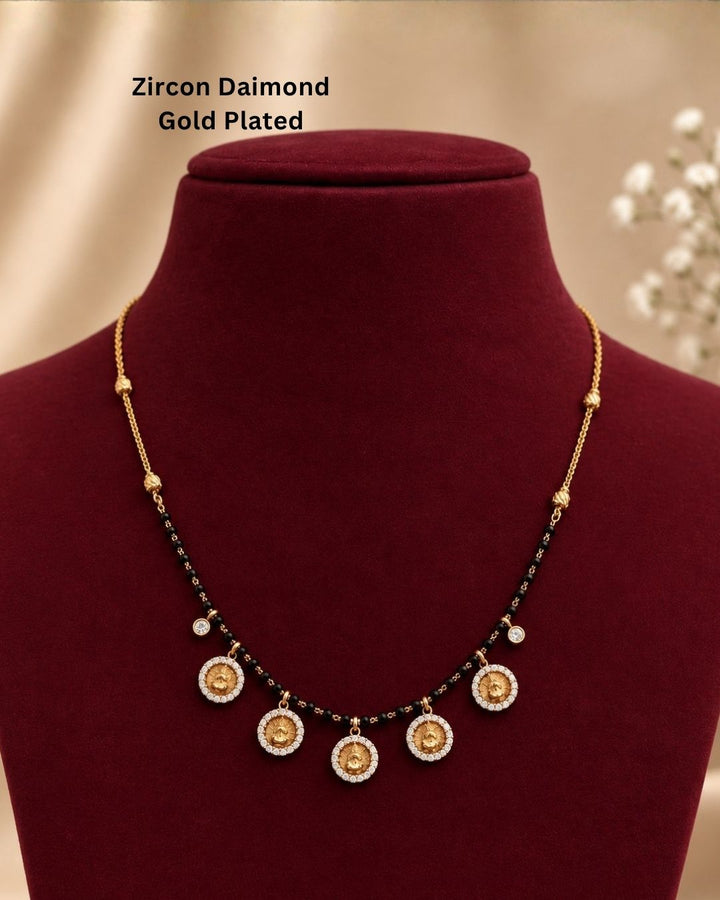 Premium gold plated mangalsutra featuring a classic black bead chain with five elegant circular coin pendants, each surrounded by sparkling clear stones. Perfect for daily wear, traditional occasions, weddings, festive celebrations, and gifting.