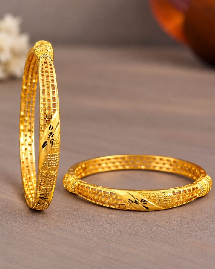 18K gold plated bangles featuring intricate geometric patterns, textured detailing, and black floral accents in an elegant traditional design.