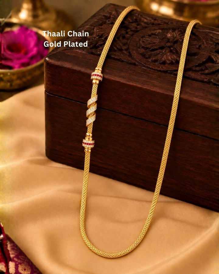 Beautiful gold plated thaali chain featuring an elegant woven pattern with ruby and CZ stone embellished decorative elements. Perfect for traditional wear, weddings, festive occasions, and gifting.