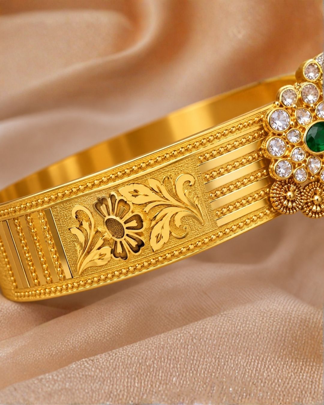 Beautiful gold plated kids hip belt featuring an intricately engraved wide band with floral motifs and a central green gemstone surrounded by sparkling clear stones. Perfect for traditional wear, weddings, festive occasions, cultural celebrations, and gifting.