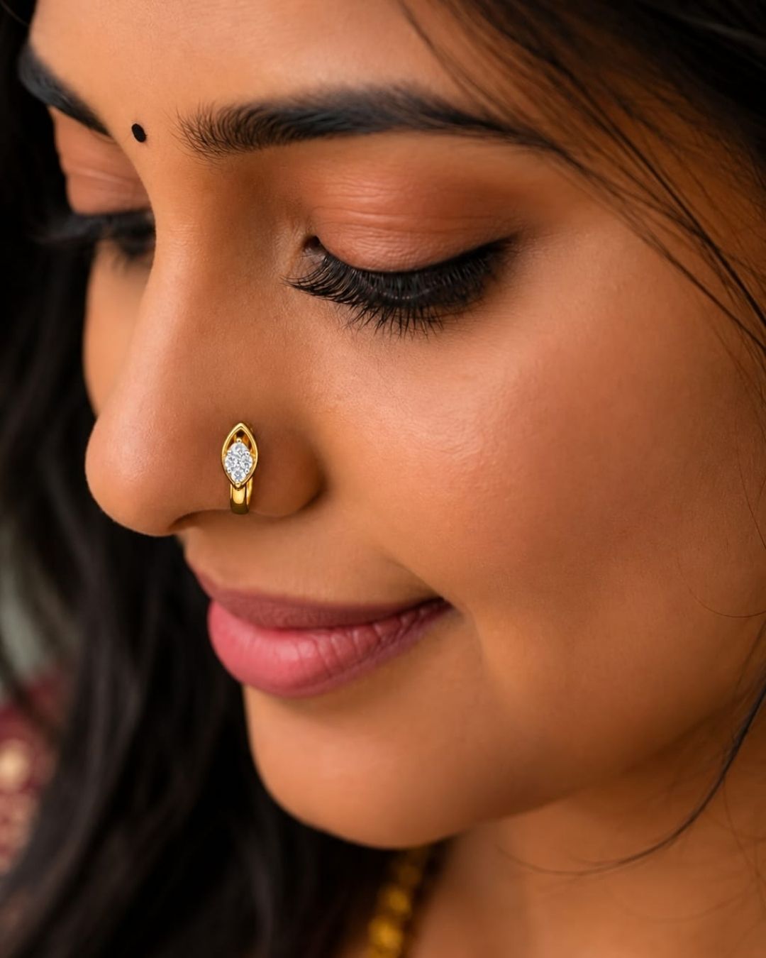 Minimal gold plated leaf design nose pin with sparkling white stones, perfect for everyday and festive wear.