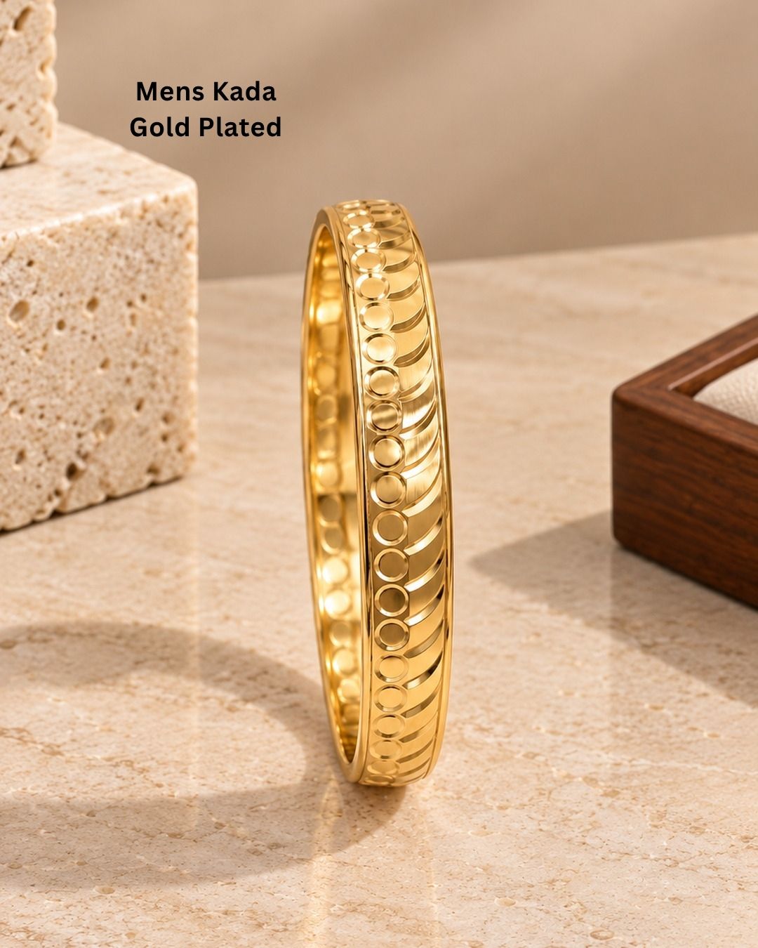 Elegant gold plated men’s kada featuring a bold circular and curved pattern design with a smooth polished finish, suitable for traditional and modern wear.